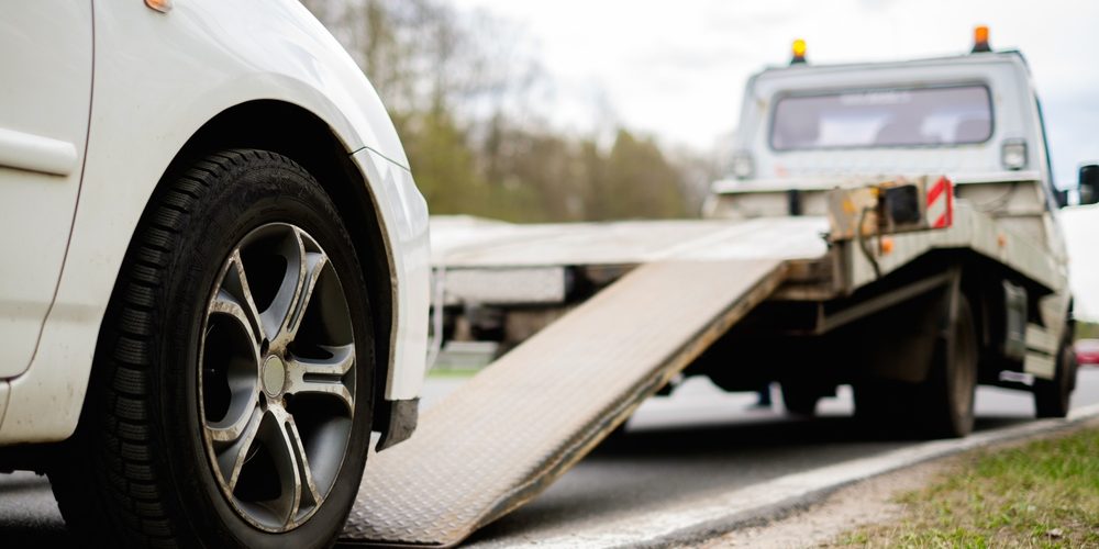 Loading Broken Car On A Tow Truck On A Roadside